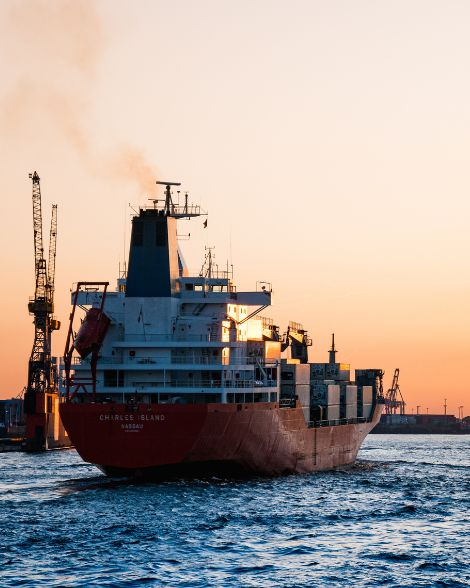 Cargo ship at port during sunset